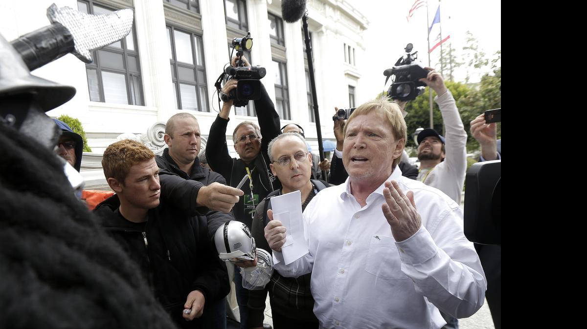 
Oakland Raiders owner Mark Davis, right, speaks to fans outside of the NFL’s spring meetings in San Francisco, Tuesday, May 19, 2015. 
