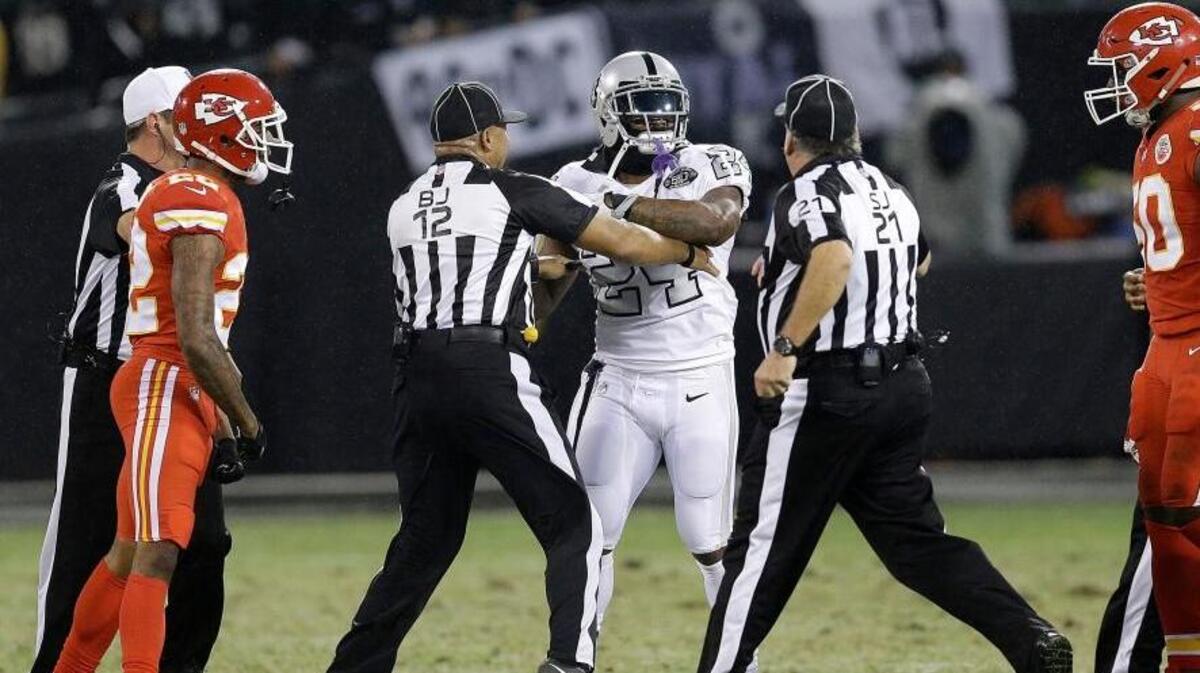 Oakland Raiders running back Marshawn Lynch (24) makes contact with back judge Greg Steed (12) during the first half against the Kansas City Chiefs in Oakland on Oct. 19. Lynch was ejected after the play.