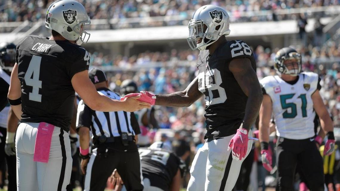 Oakland Raiders running back Latavius Murray celebrates with quarterback Derek Carr (4) after Murray’s two-yard touchdown run against the Jacksonville Jaguars during an NFL football game Sunday, Oct. 23, 2016, in Jacksonville, Fla. The Raiders stayed in Florida for the week and will face the Tampa Bay Buccaneers on Sunday, Oct. 30, 2016, in Tampa, Fla.