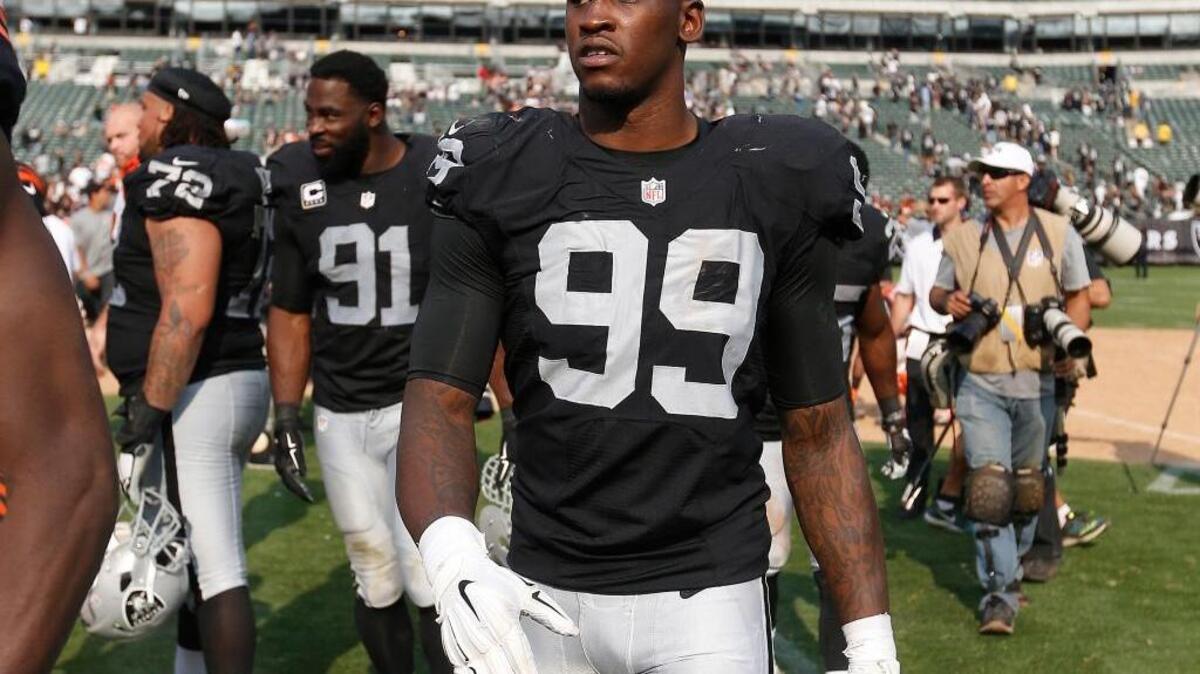 Raiders linebacker Aldon Smith (99) walks off the field after a loss to the Cincinnati Bengals on Sunday, Sept. 13, 2015, in Oakland, Calif. Smith was suspended by the NFL for one year Tuesday.