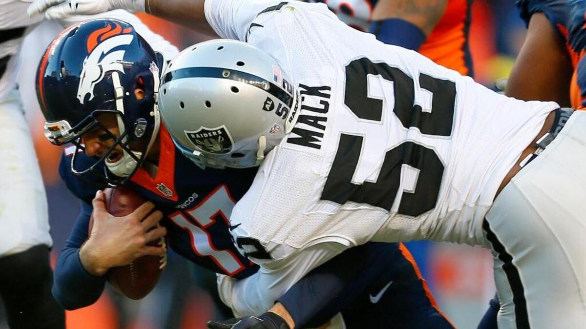 Denver Broncos quarterback Brock Osweiler (17) is sacked by Oakland Raiders defensive end Khalil Mack (52) during the second half of an NFL football game, Sunday, Dec. 13, 2015, in Denver. It was one of five sacks in the game – all coming in the second half – for Mack.