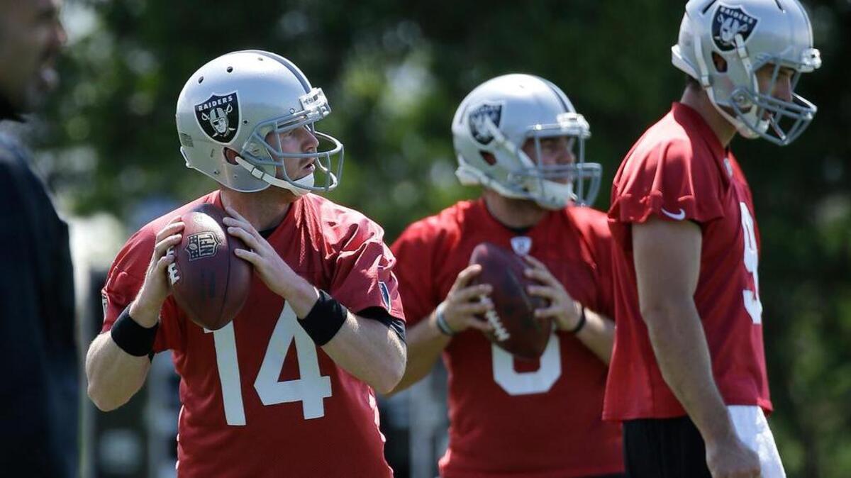 
Raiders quarterbacks Matt McGloin, left, and Cody Fajardo, center, pass behind Christian Ponder during practice in Alameda on June 2. The three QBs will fight for spots behind Derek Carr.
