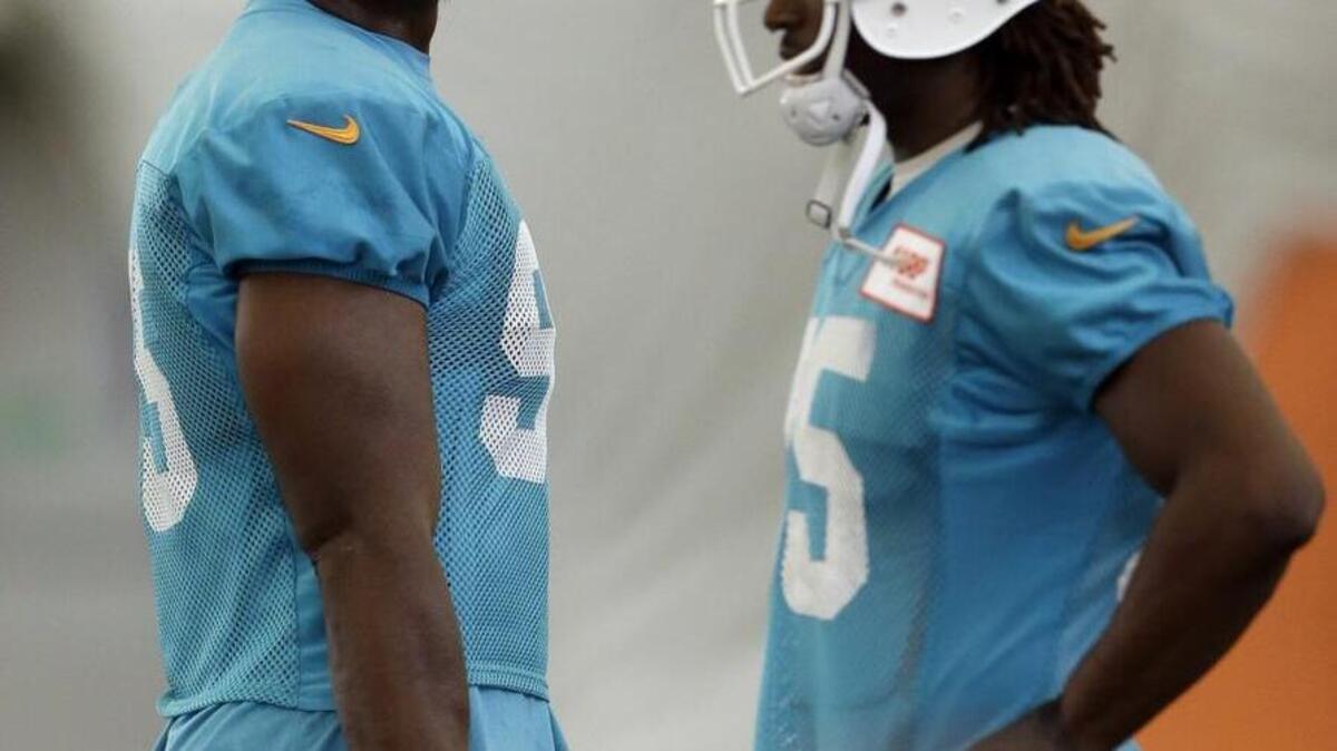 
The 16-game suspension levied by the NFL against Miami Dolphins defensive end Dion Jordan, left, cost the player more than $5 million. He was one of several players missing games and money on the league’s orders.
