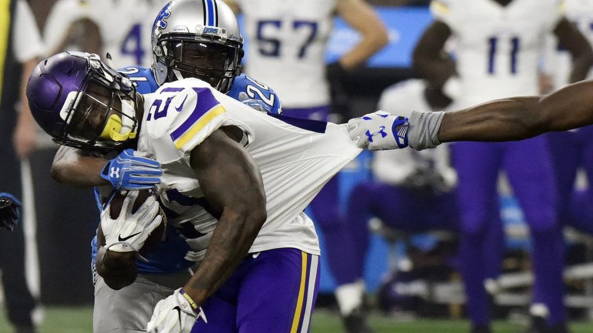 Minnesota Vikings running back Jerick McKinnon is stopped by Detroit Lions cornerback Nevin Lawson on Thursday, Nov. 24, 2016 in Detroit.