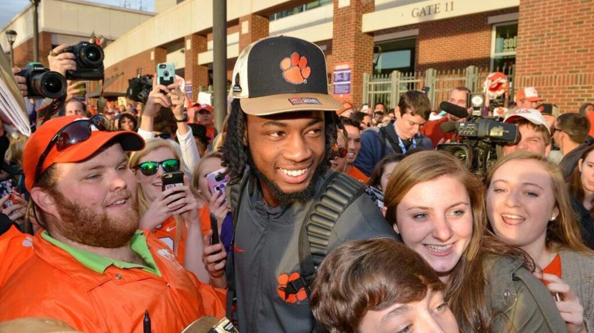 Clemson’s Mike Williams poses for photos with fans Tuesday, Jan. 10, 2017, in Clemson, S.C., the day after the Tigers defeated Alabama 35-31 in the College Football Playoff championship NCAA college football game in Tampa, Fla. Williams had eight catches for 94 yards and a touchdown.