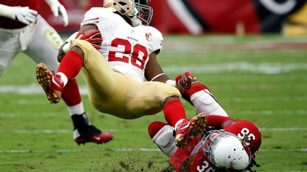 San Francisco 49ers running back Carlos Hyde (28) is tackled by Arizona Cardinals defensive back D.J. Swearinger (36) during an NFL football game, Sunday, Nov. 13, 2016, in Glendale, Ariz. Hyde is his team’s top rusher with 443 yards. He’s scored six touchdowns.