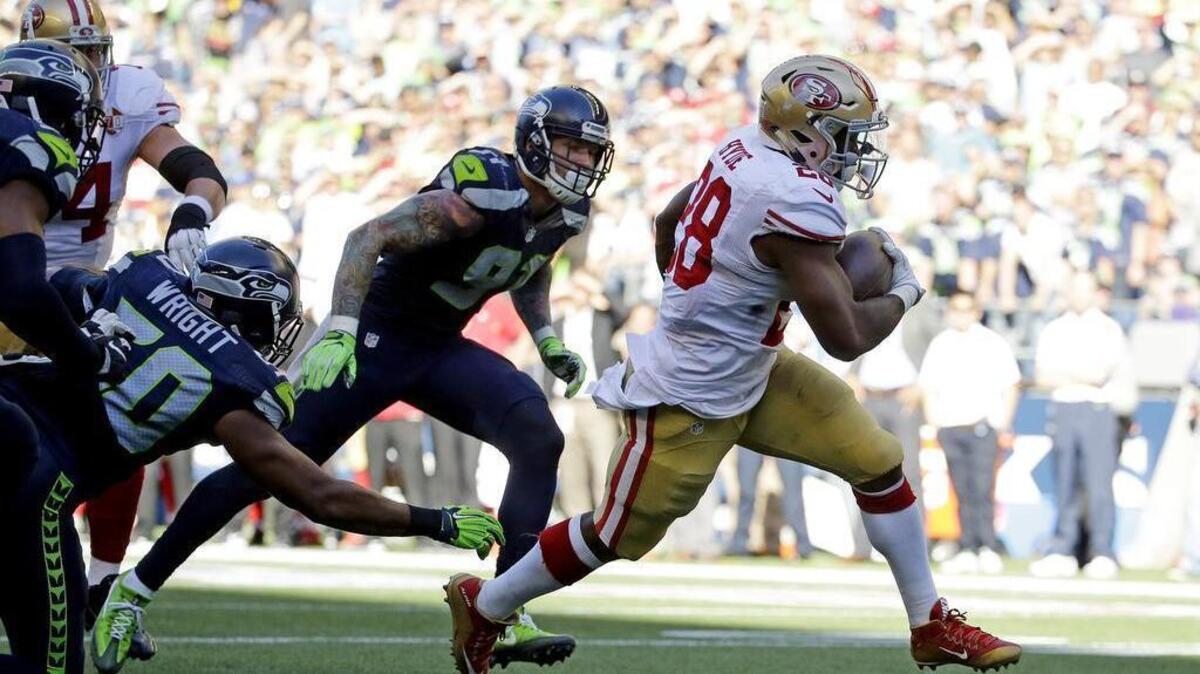 The 49ers’ Carlos Hyde rushes for one of his two touchdowns. Both came on 8-yard runs in the fourth quarter after San Francisco trailed 37-3.