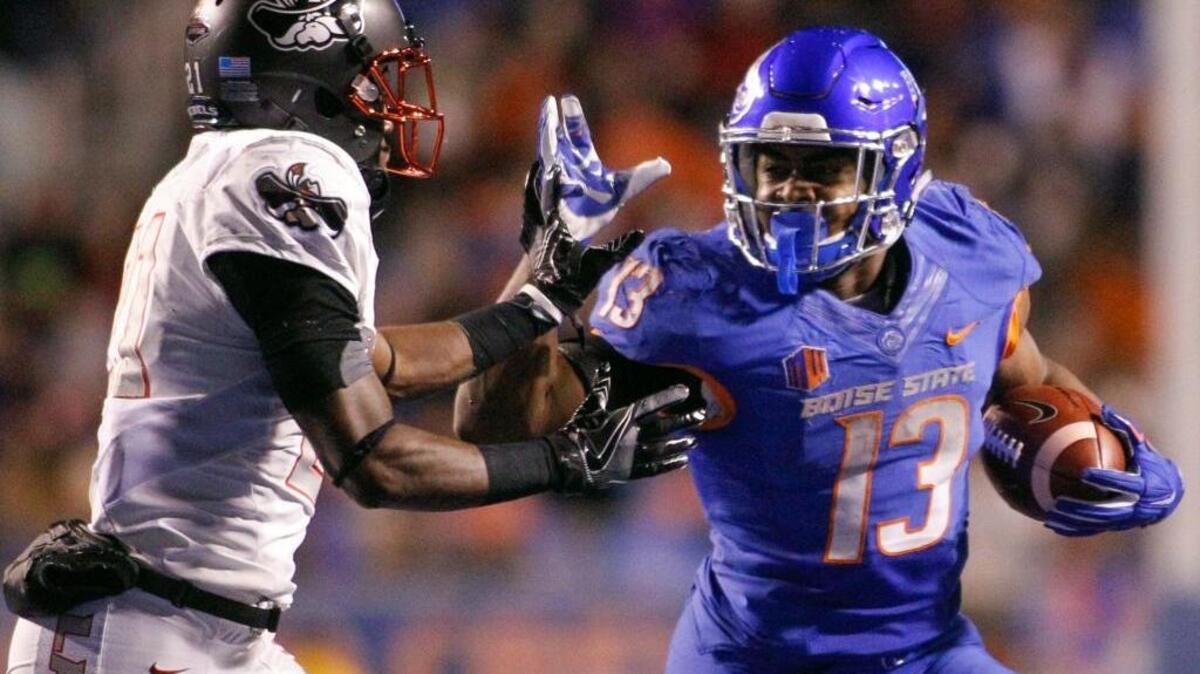 Boise State running back Jeremy McNichols (13) runs the ball against UNLV defensive back Darius Mouton (21) during the second half of an NCAA college football game in Boise, Idaho, Friday, Nov. 18, 2016. Boise State won 42-25.