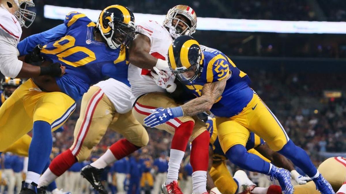St. Louis Rams defensive tackle Michael Brockers, left, and linebacker James Laurinaitis tackle San Francisco 49ers running back Mike Davis during an NFL football game Sunday, Nov. 1, 2015, in St. Louis.