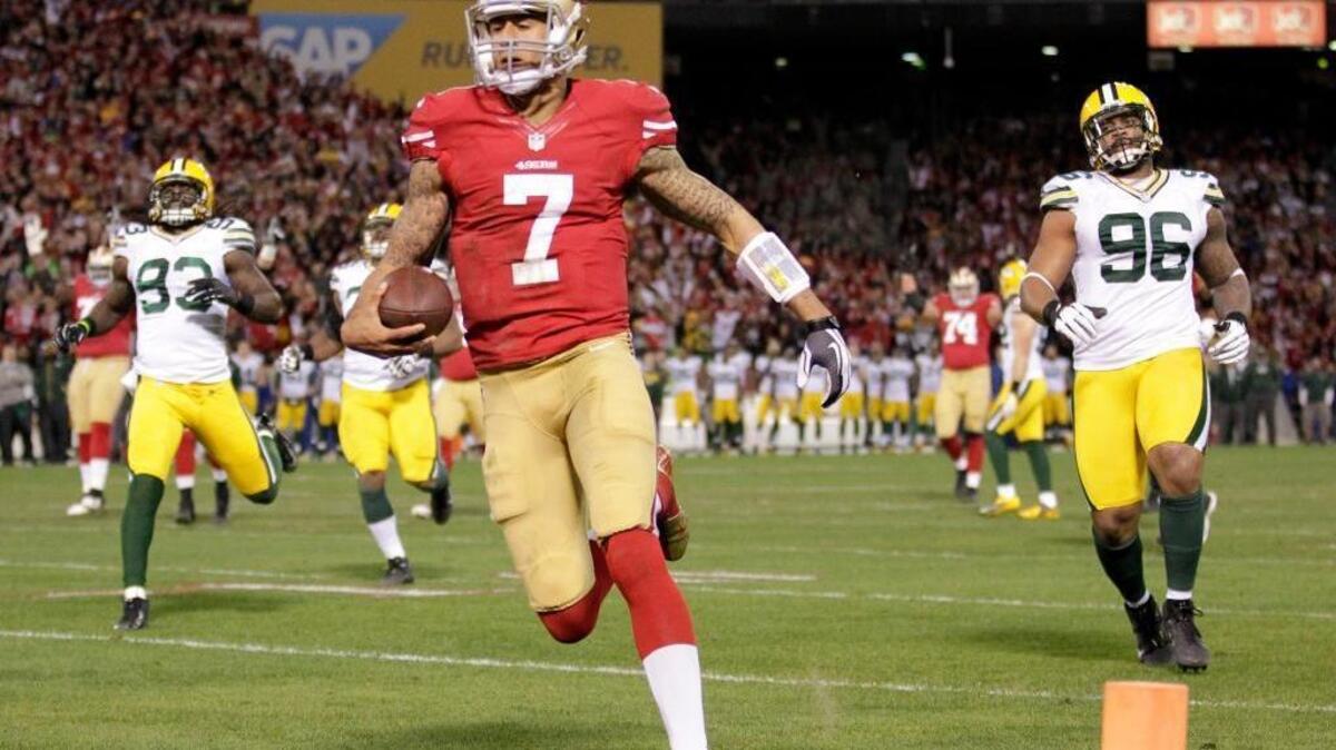 
Quarterback Colin Kaepernick slips into the end zone on a 20-yard touchdown run in a 45-31 playoff victory over the Packers in January of 2013.

