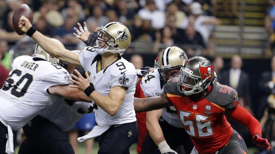 New Orleans Saints quarterback Drew Brees (9) loses the ball as he is hit by Tampa Bay Buccaneers defensive end Jacquies Smith (56) in the first half of an NFL football game in New Orleans.