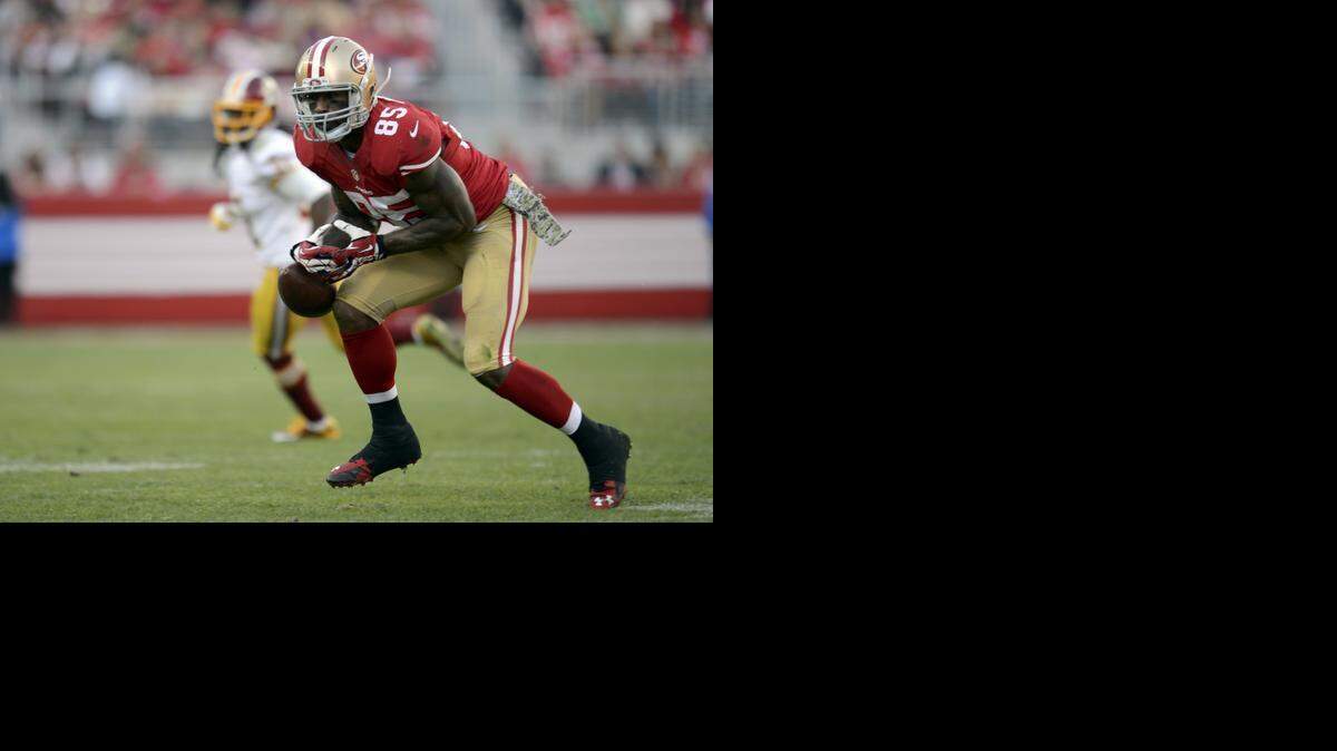 
San Francisco 49ers tight end Vernon Davis (85) drops pass by San Francisco 49ers quarterback Colin Kaepernick (7) in the third quarter during a game against the Washington Redskins at Levi's Stadium Sunday November 23, 2014 in Santa Clara.
