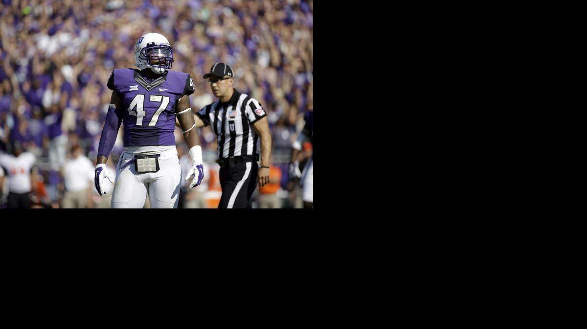 
TCU linebacker Paul Dawson (47) stands on the field looking to the sideline during the first half of an NCAA college football game against Oklahoma State, Saturday, Oct. 18, 2014, in Fort Worth, Texas.
