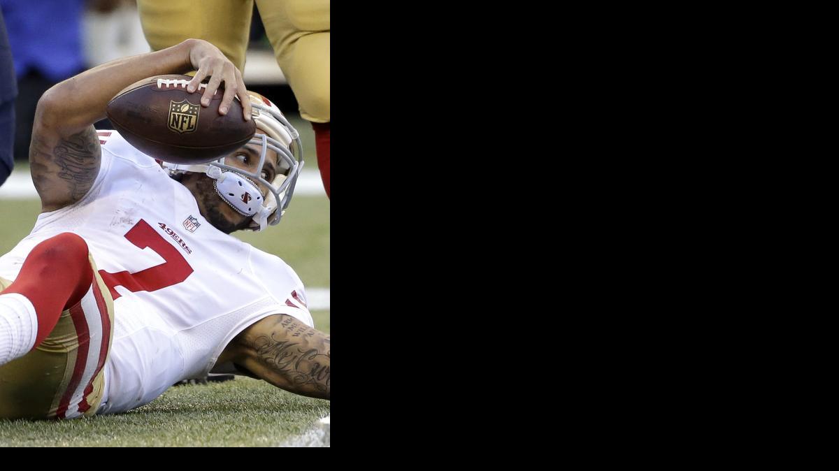 
49ers quarterback Colin Kaepernick gets up after being sacked in the second half Sunday against Seattle. Despite such scenes in the 17-7 loss to the Seahawks, coach Jim Harbaugh said he liked the effort put forth by his team.
