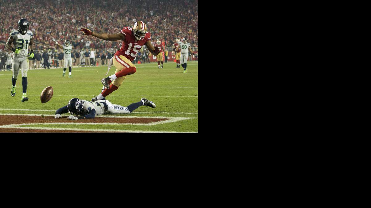 
Seattle cornerback Tharold Simon (27) breaks up a pass to 49ers wide receiver Michael Crabtree (15) in the third quarter at Levi’s Stadium on Thursday, November 27, 2014 in Santa Clara, Calif.
