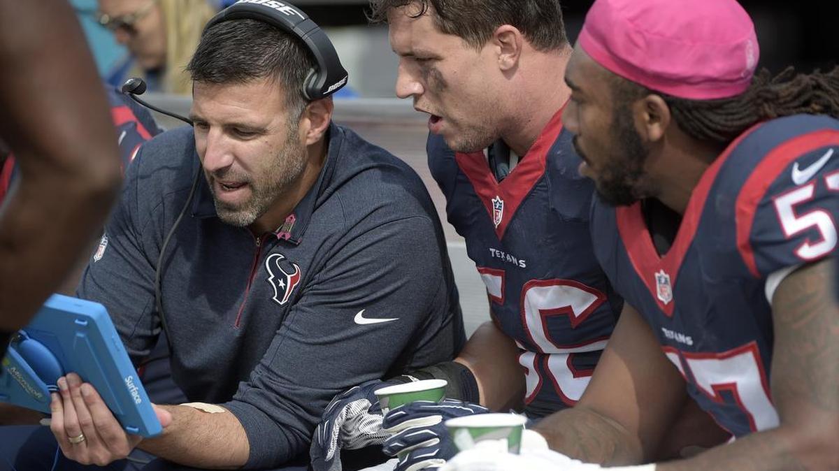 Houston Texans linebackers coach Mike Vrabel, left, talks with inside linebacker Brian Cushing (56) and inside linebacker Justin Tuggle (57) on the bench during the second half an NFL football game against the Jacksonville Jaguars in Jacksonville, Fla., Sunday, Oct. 18, 2015. The Texans won 31-20.