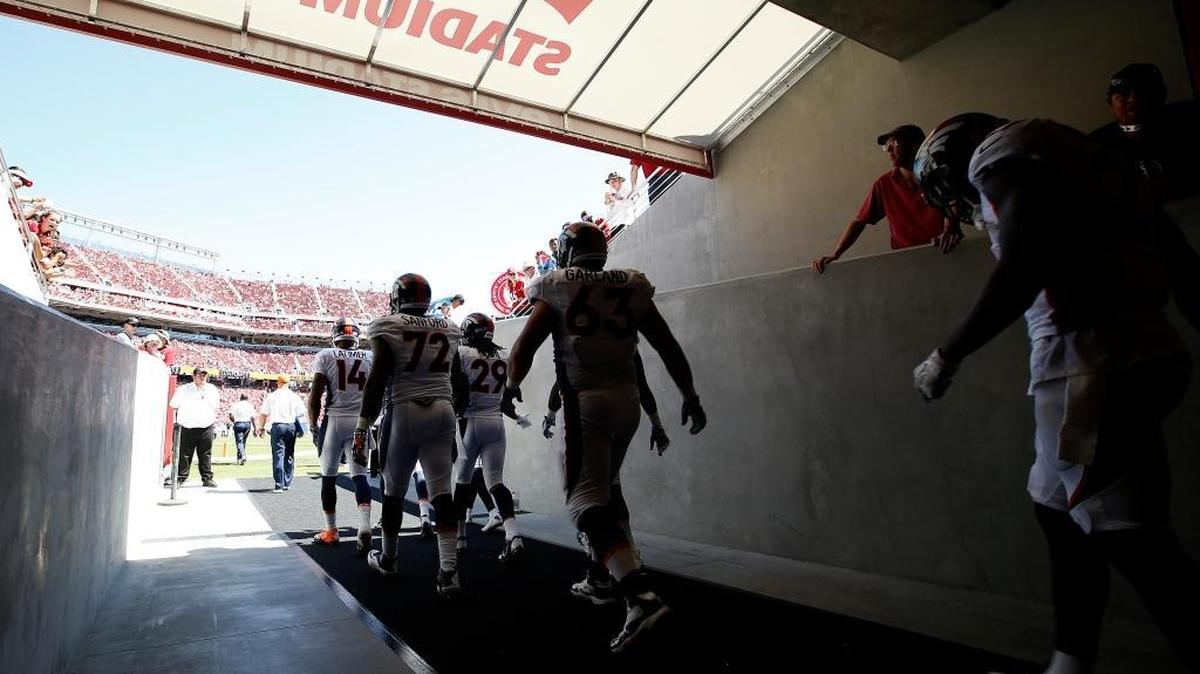 Denver Broncos players walk out of a tunnel to the Levi's Stadium field during an NFL preseason football game against the San Francisco 49ers in Santa Clara, Calif., Sunday, Aug. 17, 2014.