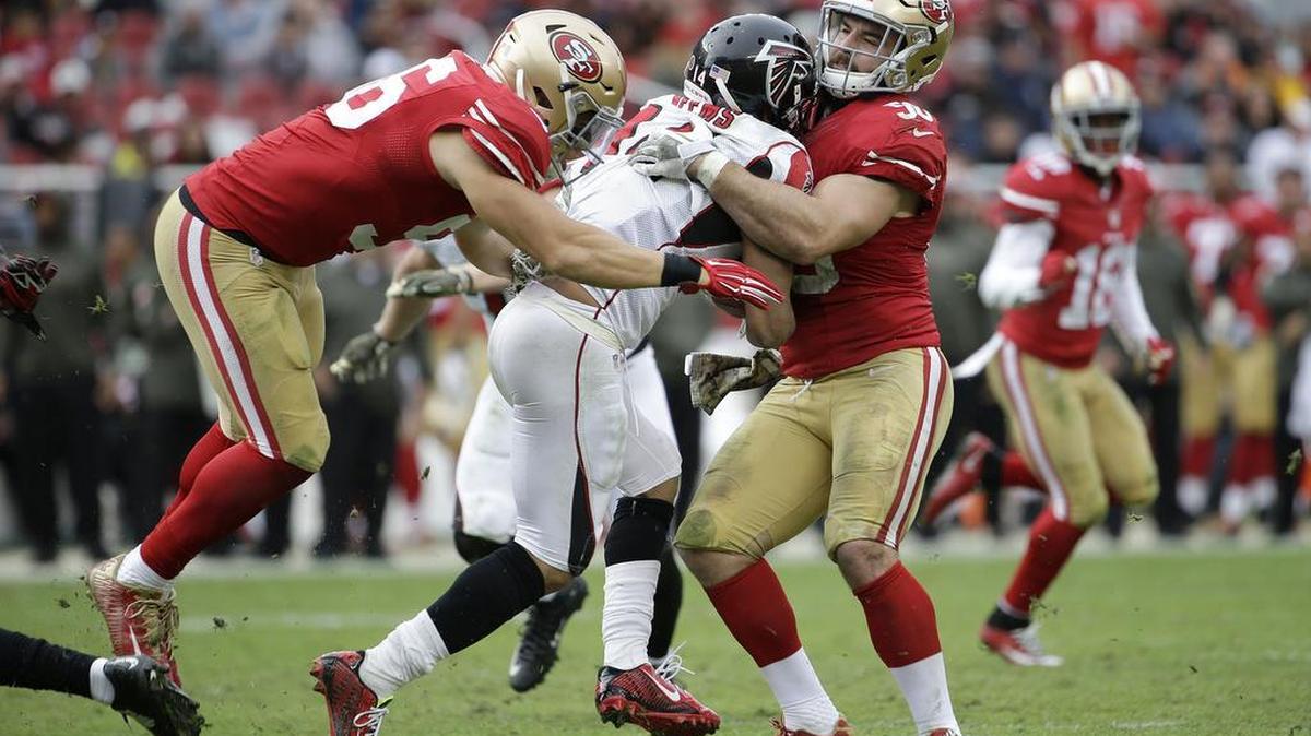 Atlanta Falcons wide receiver Eric Weems, center, is tackled by San Francisco 49ers linebacker Shayne Skov (56) and linebacker Nick Bellore (50) during an NFL football game in Santa Clara, Calif., Sunday, Nov. 8, 2015.