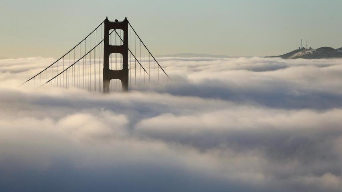 Fog blankets the south tower of the Golden Gate Bridge in San Francisco on Friday, Oct. 21, 2016.