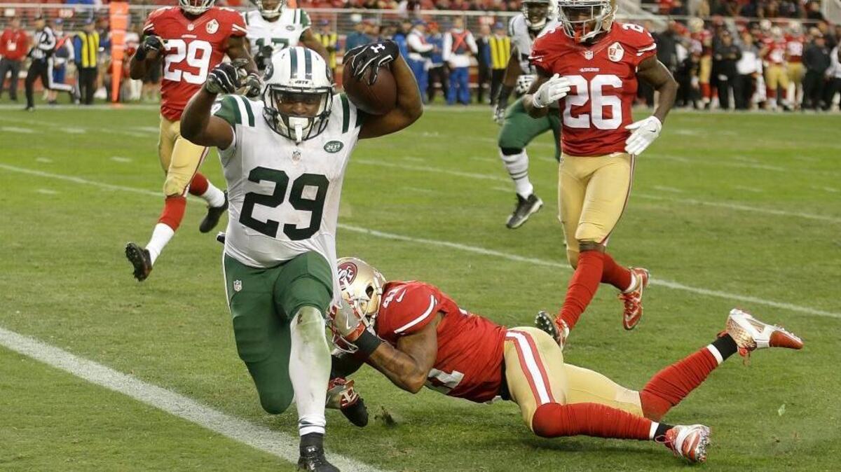 New York Jets running back Bilal Powell (29) runs past 49ers strong safety Antoine Bethea to score the winning touchdown in overtime of the Jets 23-17 victory at Levi’s Stadium on Sunday.