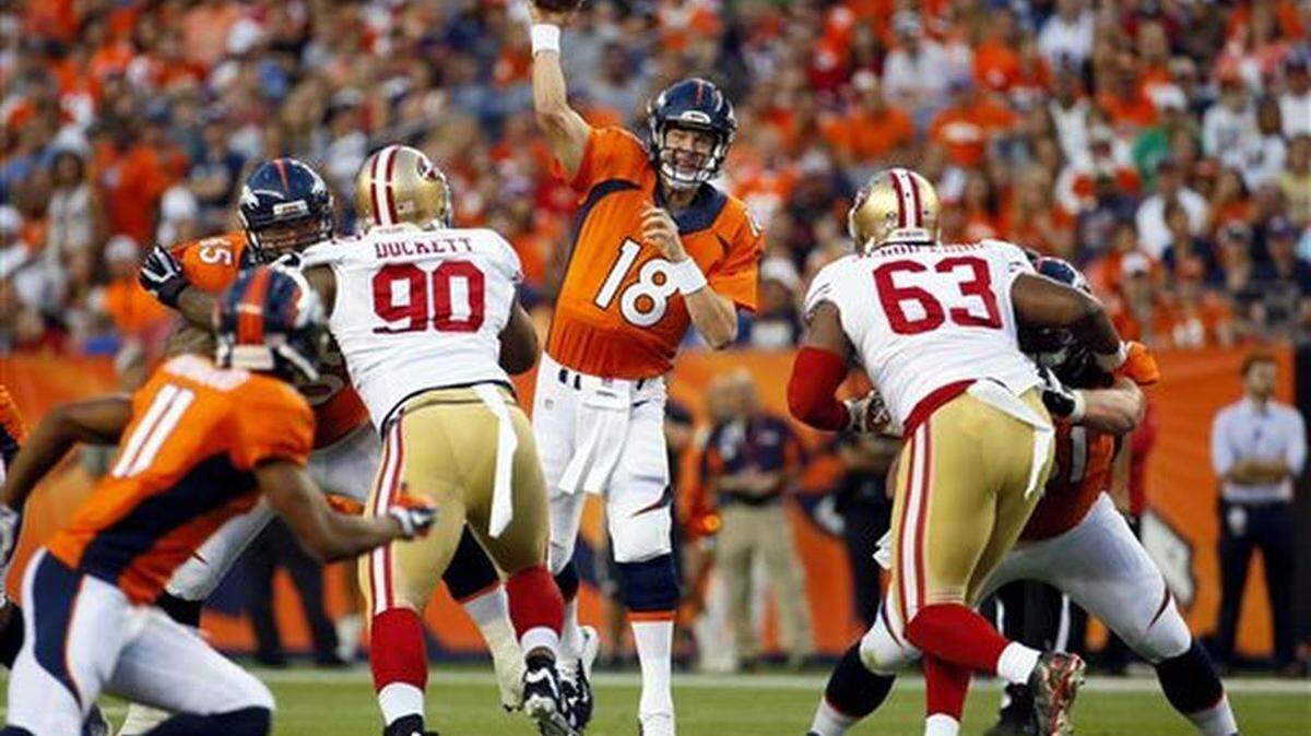 Denver Broncos quarterback Peyton Manning (18) throws as San Francisco 49ers defensive tackle Darnell Dockett (90) and Tony Jerod-Eddie (63) rush during the first half of an NFL preseason football game, Saturday, Aug. 29, 2015, in Denver.