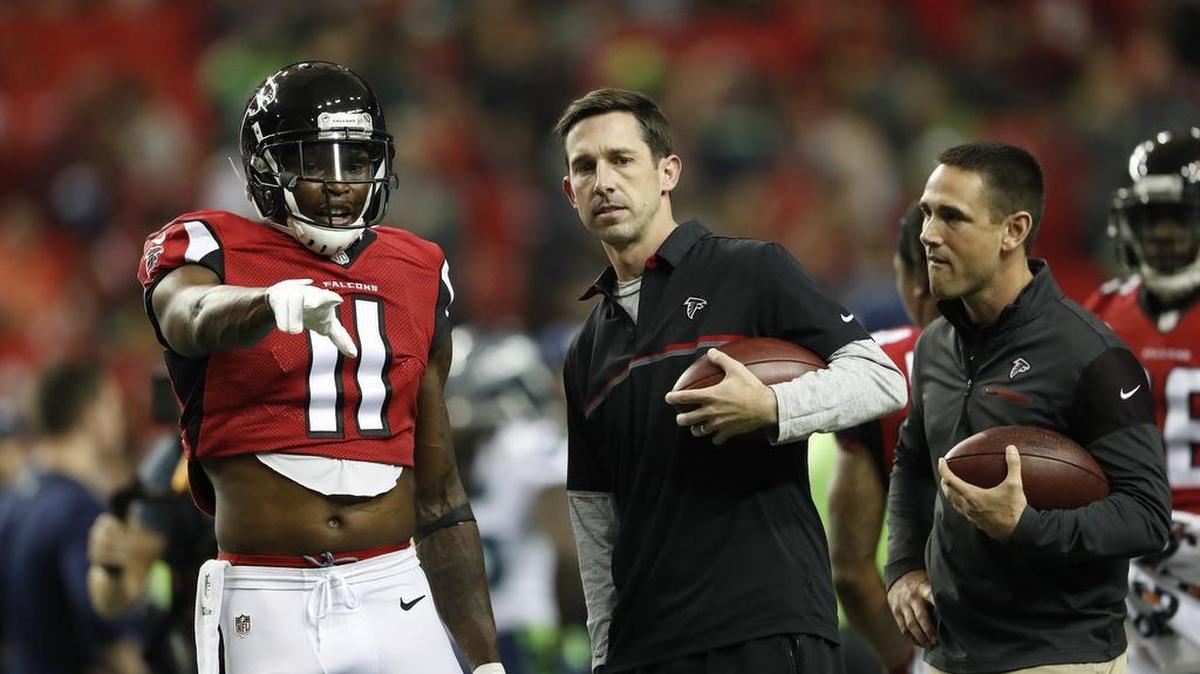 Atlanta Falcons Offensive Coordinator Kyle Shanahan speaks with Atlanta Falcons wide receiver Julio Jones (11) before the first half of an NFL football NFC divisional playoff game between the Atlanta Falcons and the Seattle Seahawks, Saturday, Jan. 14, 2017, in Atlanta.