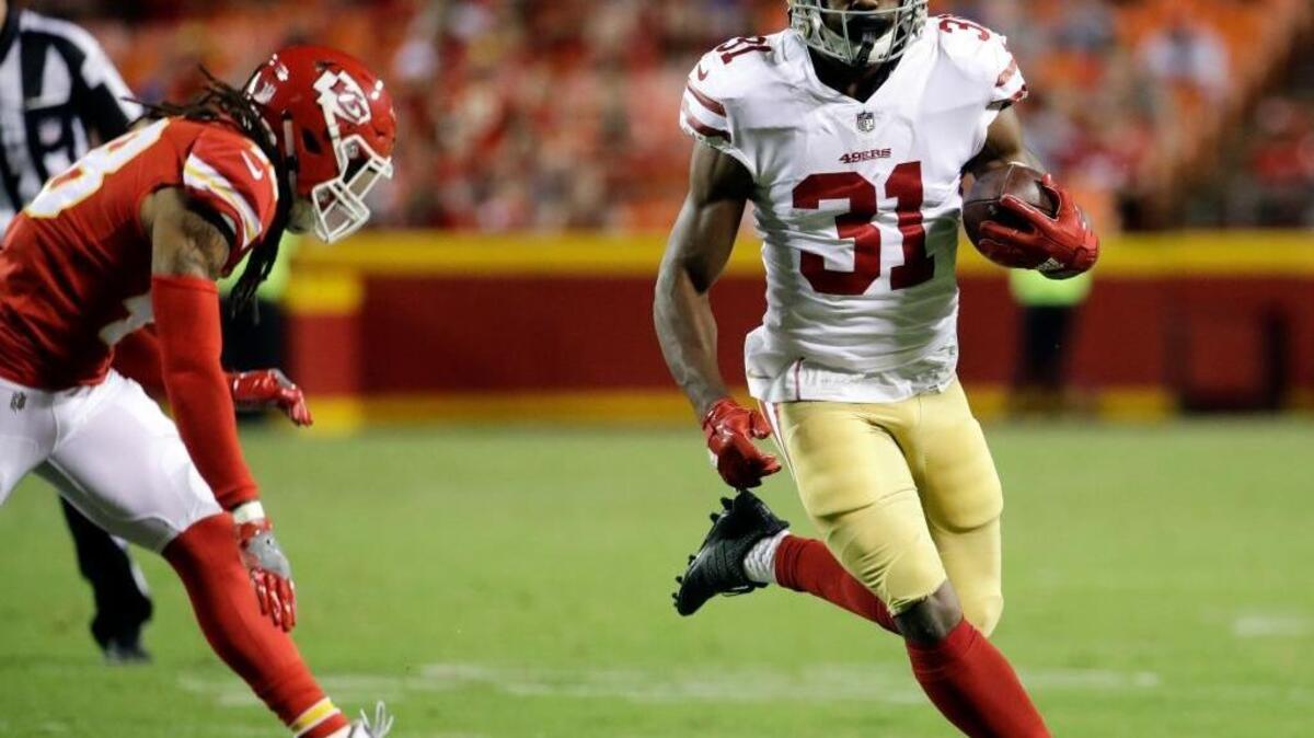 San Francisco 49ers running back Raheem Mostert (31) runs away from Kansas City Chiefs linebacker Terrance Smith (48) during the second half of an NFL preseason football game in Kansas City, Mo., Friday, Aug. 11, 2017.
