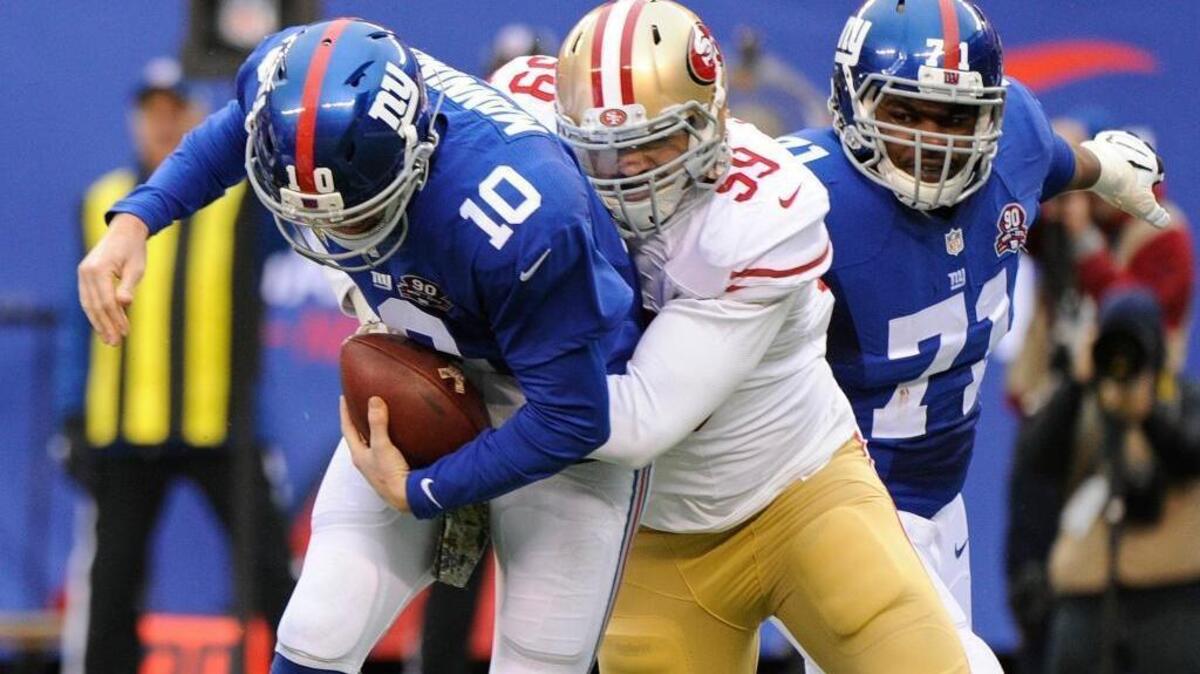 
San Francisco 49ers outside linebacker Aaron Lynch (59) beats New York Giants' Charles Brown (71) to sack Giants quarterback Eli Manning (10) during the second half of an NFL football game Sunday, Nov. 16, 2014, in East Rutherford, N.J. 
