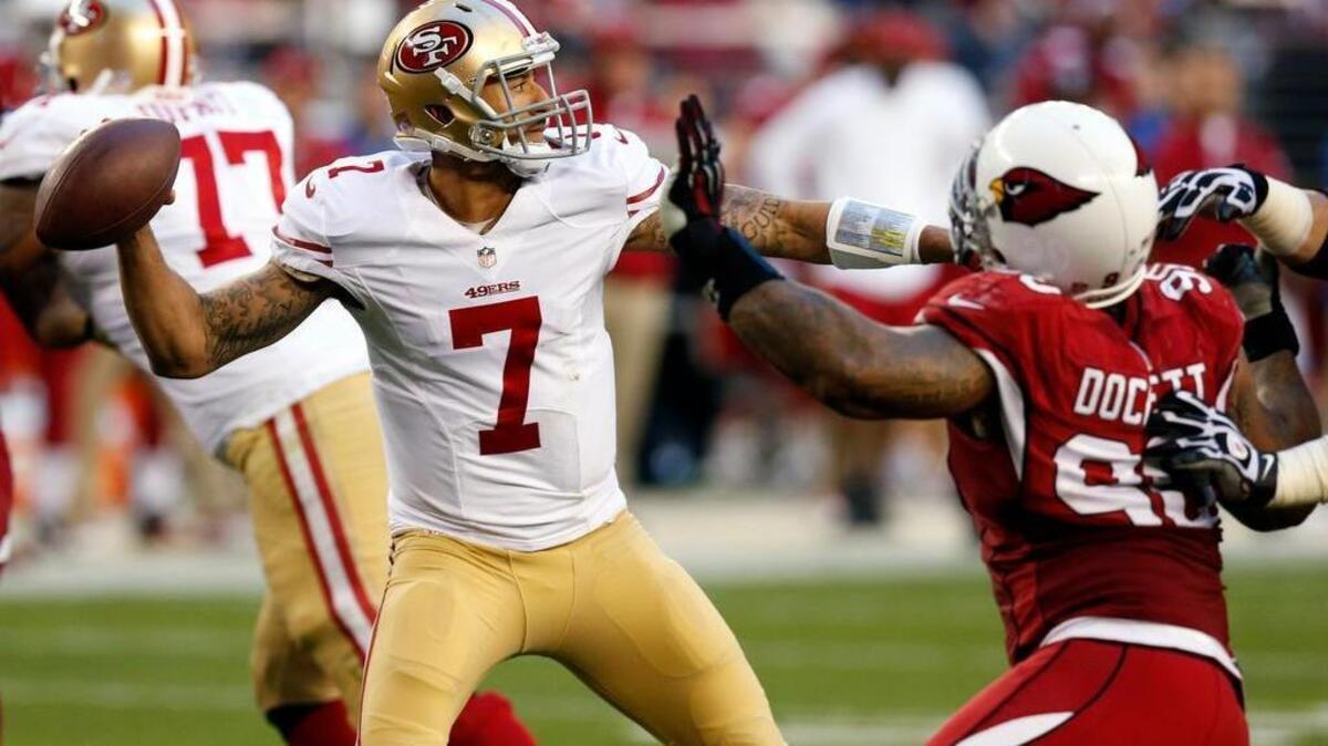 
Arizona’s Darnell Dockett chases 49ers quarterback Colin Kaepernick (7) during a game in 2013. The only time Kaepernick will have to worry about Dockett is in practice, as they are teammates now.

