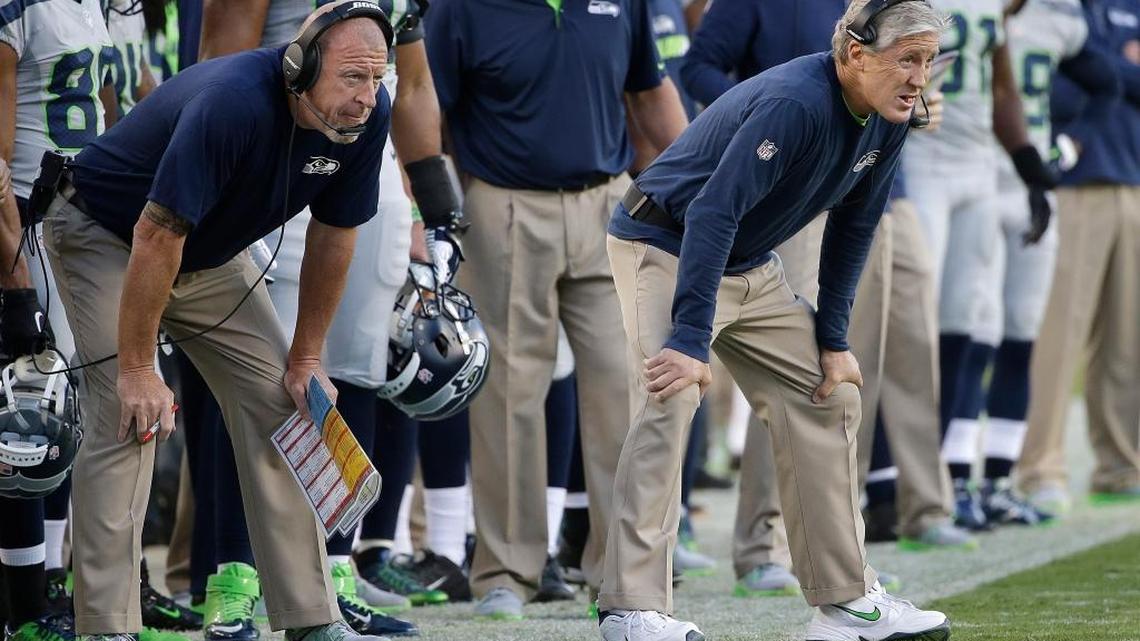 Seattle Seahawks assistant coach Tom Cable, left, and Pete Carroll watch during the first half of an NFL football game against the San Francisco 49ers in Santa Clara, Calif., Thursday, Oct. 22, 2015.