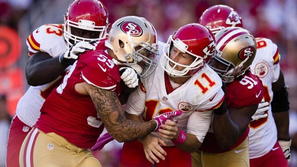 Aaron Lynch (59) is among the 49ers to get to Kansas City quarterback Alex Smith during a game in 2014.