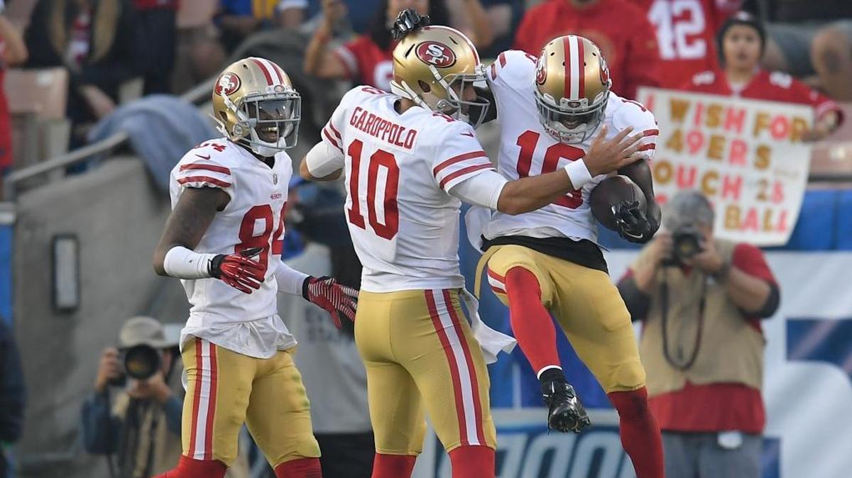San Francisco 49ers wide receiver Aldrick Robinson, right, celebrates after scoring with quarterback Jimmy Garoppolo during the second half of an NFL football game against the Los Angeles Rams Sunday, Dec. 31, 2017, in Los Angeles.