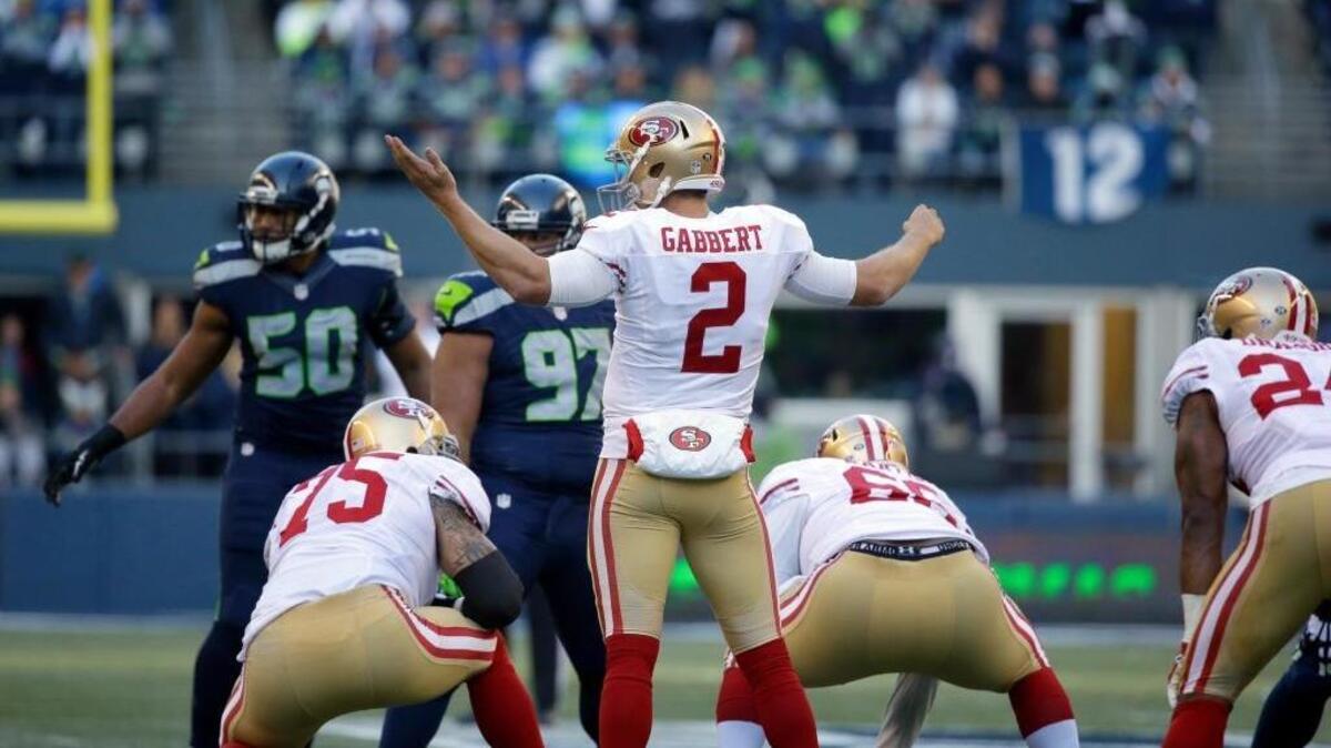 San Francisco 49ers quarterback Blaine Gabbert (2) gestures at the line of scrimmage during the first half of an NFL football game against the Seattle Seahawks, Sunday, Nov. 22, 2015, in Seattle.