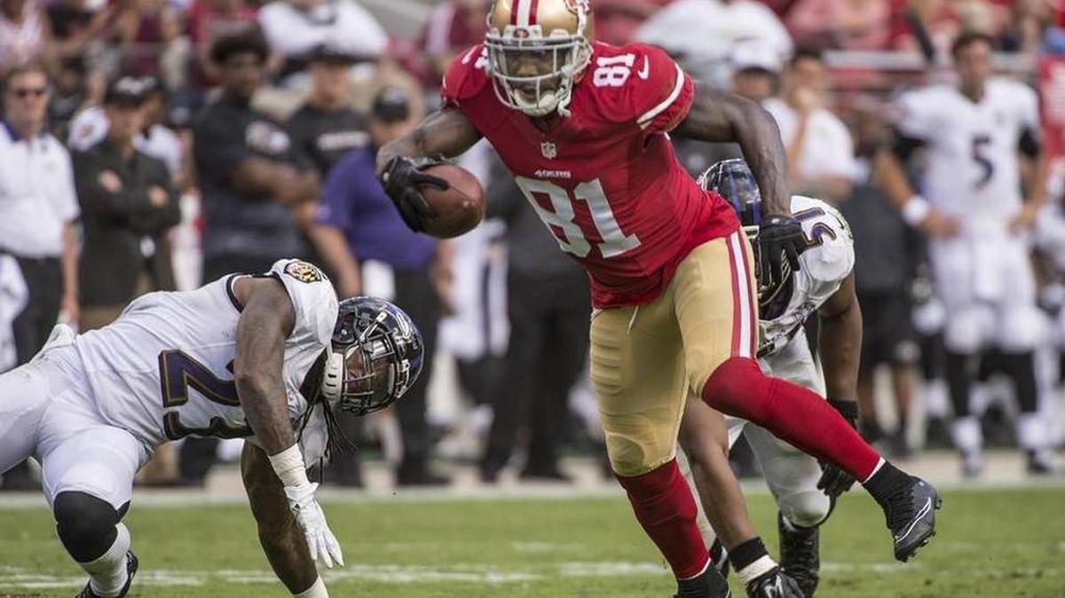 
49ers receiver Anquan Boldin breaks tackles for a big gain in the third quarter against the Baltimore Ravens.

