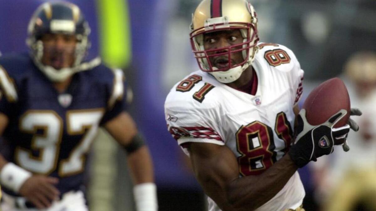 San Francisco 49ers' Terrell Owens out runs San Diego Chargers safety Rodney Harrison with a 76 yard touchdown pass in the third quarter of their game Sunday Nov. 17, 2002 in San Diego.
