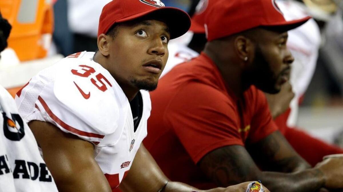 
San Francisco 49ers free safety Eric Reid (35) looks up at the scoreboard as he sits on the bench during the second quarter of an NFL football preseason game against the Houston Texans Thursday, Aug. 28, 2014, in Houston. 
