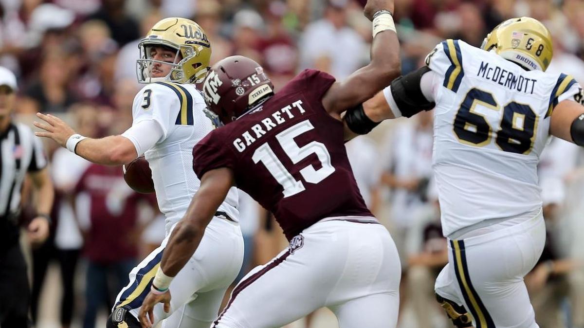UCLA quarterback Josh Rosen (3) is pressured by Texas A&M Myles Garrett (15) during the first quarter of an NCAA college football game Saturday, Sept. 3, 2016, in College Station, Texas.