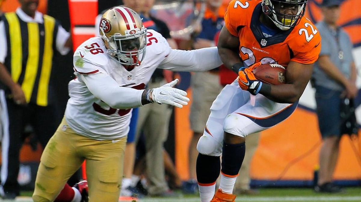 
Denver Broncos running back C.J. Anderson (22) gets away from the attempted tackle of San Francisco 49ers outside linebacker Eli Harold (58) during the first half of an NFL preseason football game, Saturday, Aug. 29, 2015, in Denver. 
