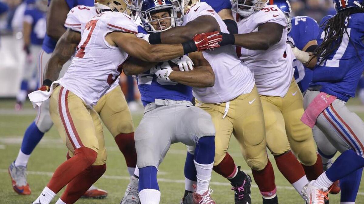 
New York Giants running back Rashad Jennings (23) is tackled by the San Francisco 49ers during the second quarter of an NFL football game, Sunday, Oct. 11, 2015, in East Rutherford, N.J. 
