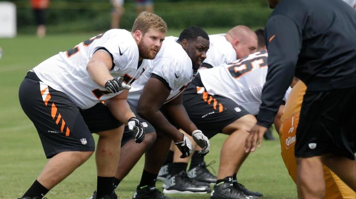 
Cincinnati Bengals’ Tanner Hawkinson, left, runs a play during practice at the NFL football team's training camp, Saturday, July 26, 2014, in Cincinnati. 
