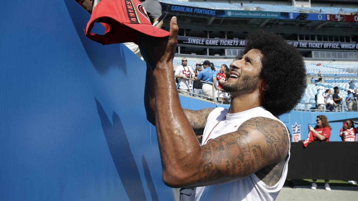 San Francisco 49ers' Colin Kaepernick signs autographs before an NFL football game against the Carolina Panthers in Charlotte, N.C., Sunday, Sept. 18, 2016.