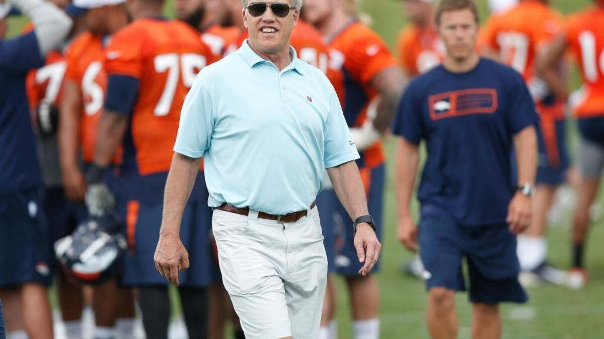 
John Elway, Denver Broncos general manager and executive vice president of football operations, heads off the field after an organized training activity at the NFL football team's headquarters in Englewood, Colo., Monday, June 1, 2015. 
