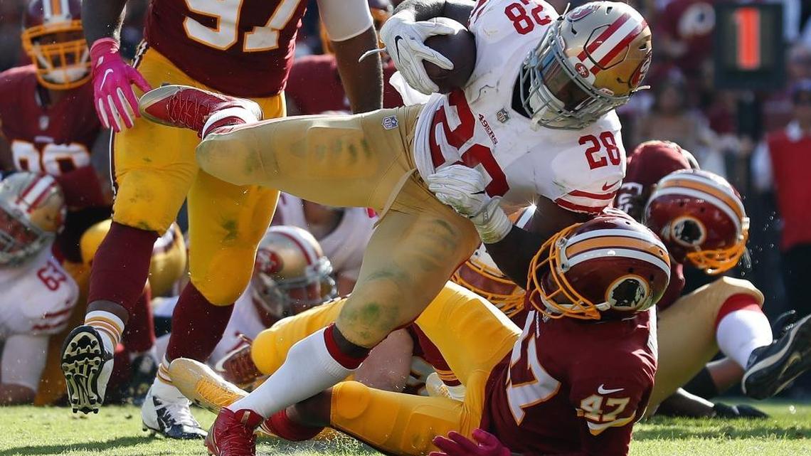 49ers running back Carlos Hyde (28) pushes his way into the end zone past Washington Redskins cornerback Quinton Dunbar (47) for a touchdown Sunday in Landover, Md.