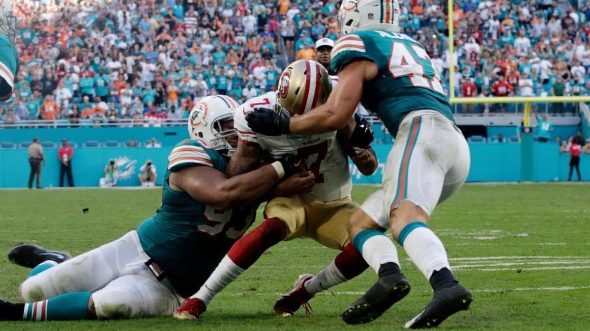 San Francisco 49ers quarterback Colin Kaepernick (7) is tackled by Miami Dolphins defensive tackle Ndamukong Suh (93) and middle linebacker Kiko Alonso (47) near the end zone, during the second half of an NFL football game, Sunday, Nov. 27, 2016, in Miami Gardens, Fla. (47). The Dolphins defeated the 49ers 31-24.