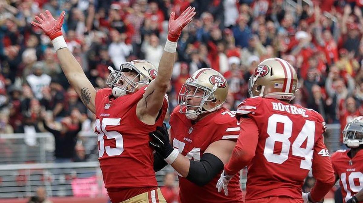 Tight end George Kittle, left, celebrates with 49ers teammates after scoring a touchdown against the Jacksonville Jaguars on Sunday at Levi’s Stadium.