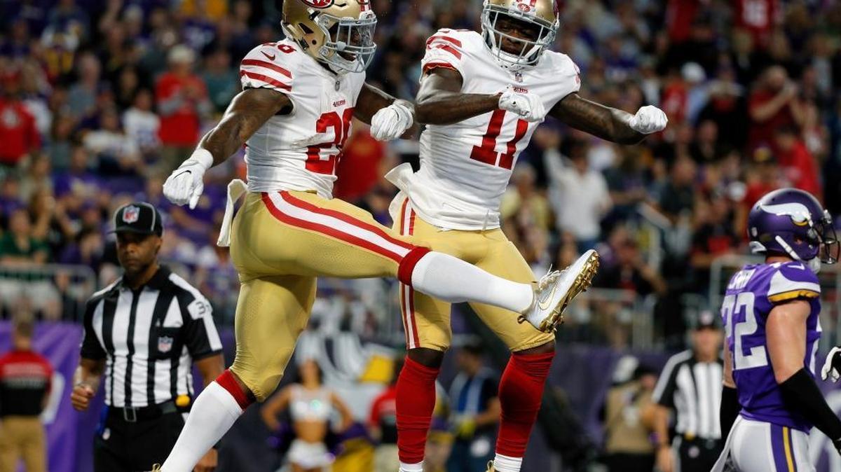 San Francisco 49ers running back Carlos Hyde, left, celebrates with teammate Marquise Goodwin (11) after catching a 24-yard touchdown pass during the first half of an NFL preseason football game against the Minnesota Vikings, Sunday, Aug. 27, 2017, in Minneapolis.