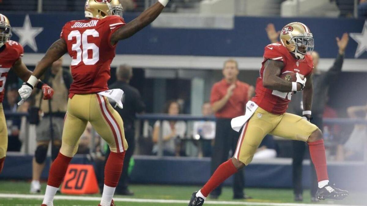 
San Francisco Dontae Johnson (36) gestures as teammate defensive back Perrish Cox (20) runs back an interception against the Dallas Cowboys in the first half of an NFL football game, Sunday, Sept. 7, 2014, in Arlington, Texas. 
