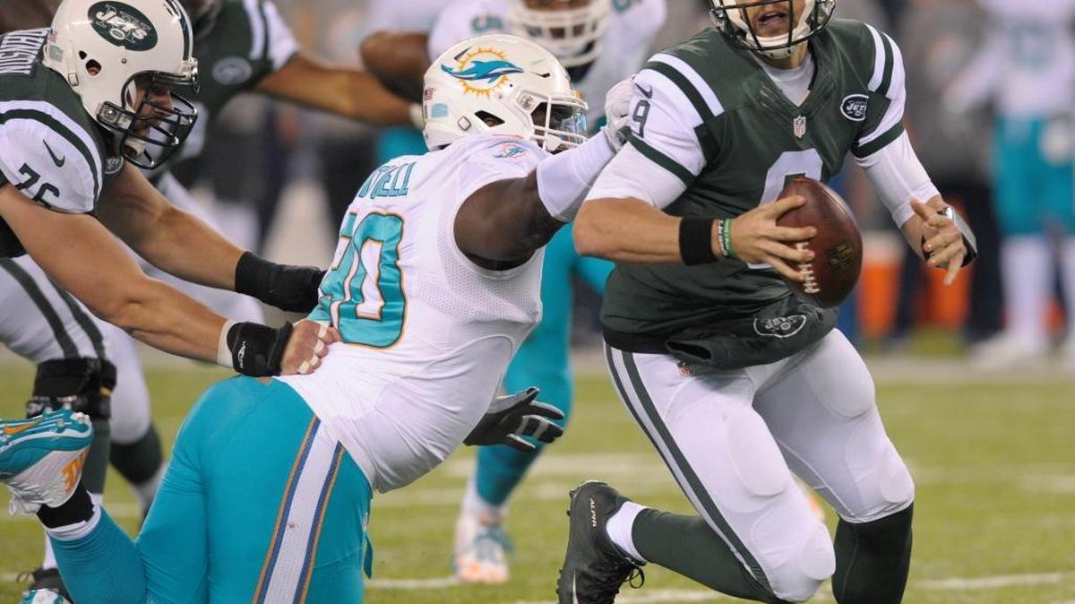 In this Saturday, Dec. 17, 2016 file photo, New York Jets quarterback Bryce Petty (9) tries to avoid Miami Dolphins defensive tackle Earl Mitchell (90) during the fourth quarter of an NFL football game in East Rutherford, N.J.
