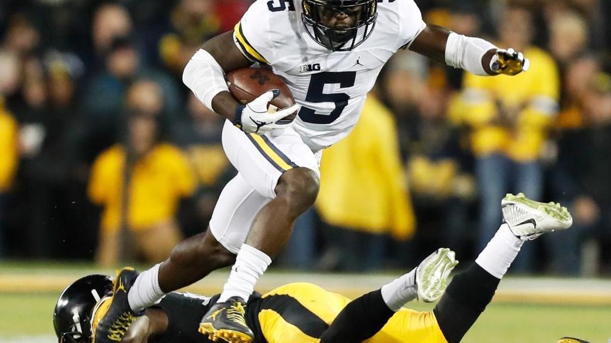 In this Nov. 12, 2016, file photo, Michigan's Jabrill Peppers (5) breaks a tackle by Iowa defensive back Desmond King, rear, during the first half of an NCAA college football game, in Iowa City, Iowa.