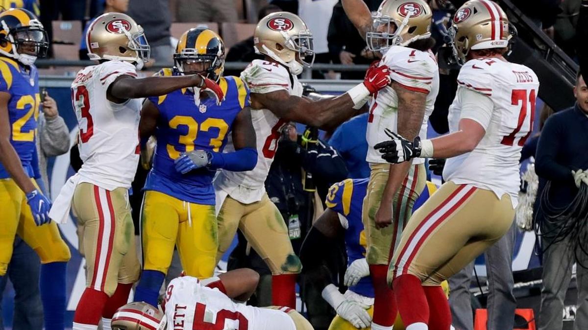 San Francisco 49ers quarterback Colin Kaepernick, second from right, celebrates after scoring a two-point conversion during the second half of an NFL football game against the Los Angeles Rams, Saturday, Dec. 24, 2016, in Los Angeles.